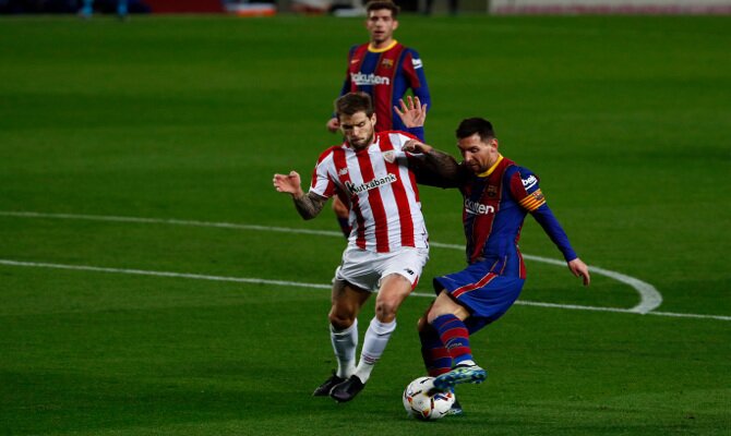 Messi e Iñigo Martínez disputan un balón. Cuotas y picks del Athletic vs Barcelona