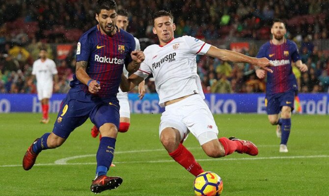 Luis Suárez (derecha) y Lenglet (izquierda) disputan un balón. Conoce las cuotas del Sevilla vs Barcelona